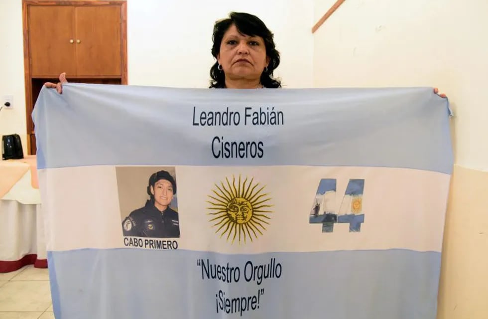 Yolanda Susana Mendiola, mother of Argentine Corporal Fabian Cisneros, poses with an Argentine national flag with a picture of him at a military hotel in Mar del Plata, Argentina, on November 07, 2018. - Cisneros was part of the crew of the Argentine submarine Ara San Juan, which went missing on November 15, 2017. (Photo by Mara SOSTI / AFP)
