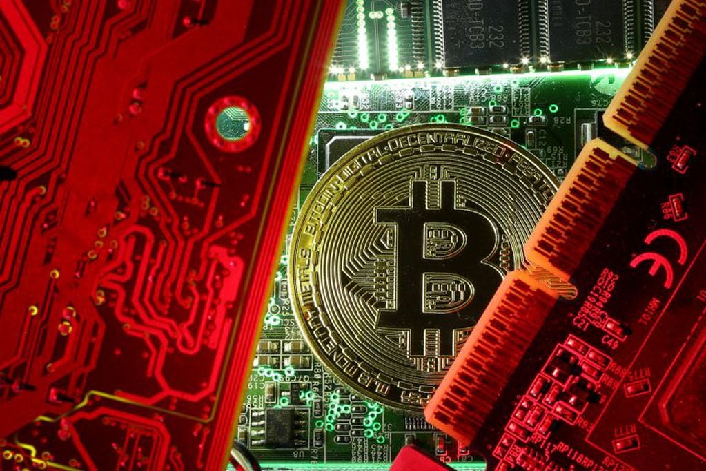 FILE PHOTO: A copy of bitcoin standing on PC motherboard is seen in this illustration picture, October 26, 2017. REUTERS/Dado Ruvic