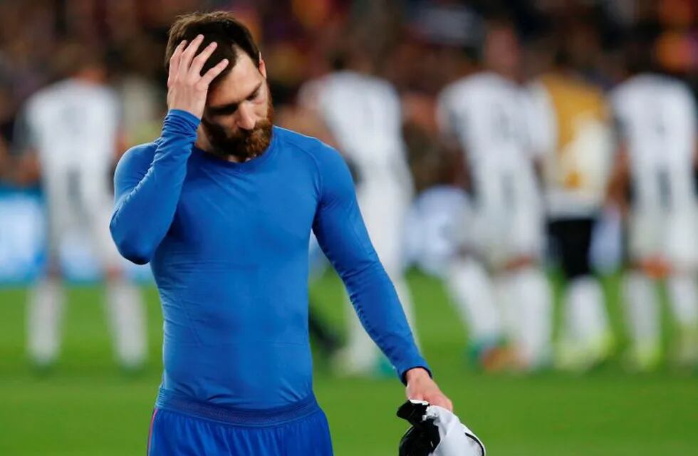 Barcelona's Argentinian forward Lionel Messi walks on the pitch at the end of the UEFA Champions League quarter-final second leg football match FC Barcelona vs Juventus at the Camp Nou stadium in Barcelona on April 19, 2017.nThe game ended with a draw and Juventus is qualified for the semis. / AFP PHOTO / PAU BARRENA