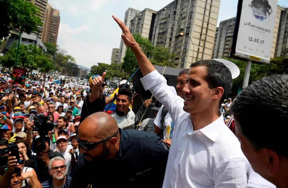 Venezuelan opposition leader Juan Guaido gestures at supporters during a rally to commemorate May Day on May 1, 2019 after a day of violent clashes on the streets of the capital spurred by his call on the military to rise up against President Nicolas Maduro. - Guaido called for a massive May Day protest to increase the pressure on President Maduro. (Photo by Federico PARRA / AFP)