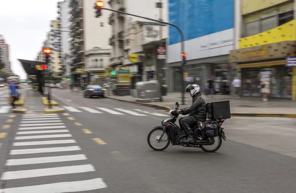 A delivery motorbike crosses Cabildo Avenue in the Belgrano neighborhood of Buenos Aires, Argentina, on Monday, April 27, 2020. The coronavirus lockdown is forcing savers to get creative about the way they use the black market to evade strict currency controls introduced in September, and ditch depreciating pesos for the safe haven of dollars. Photographer: Sarah Pabst/Bloomberg