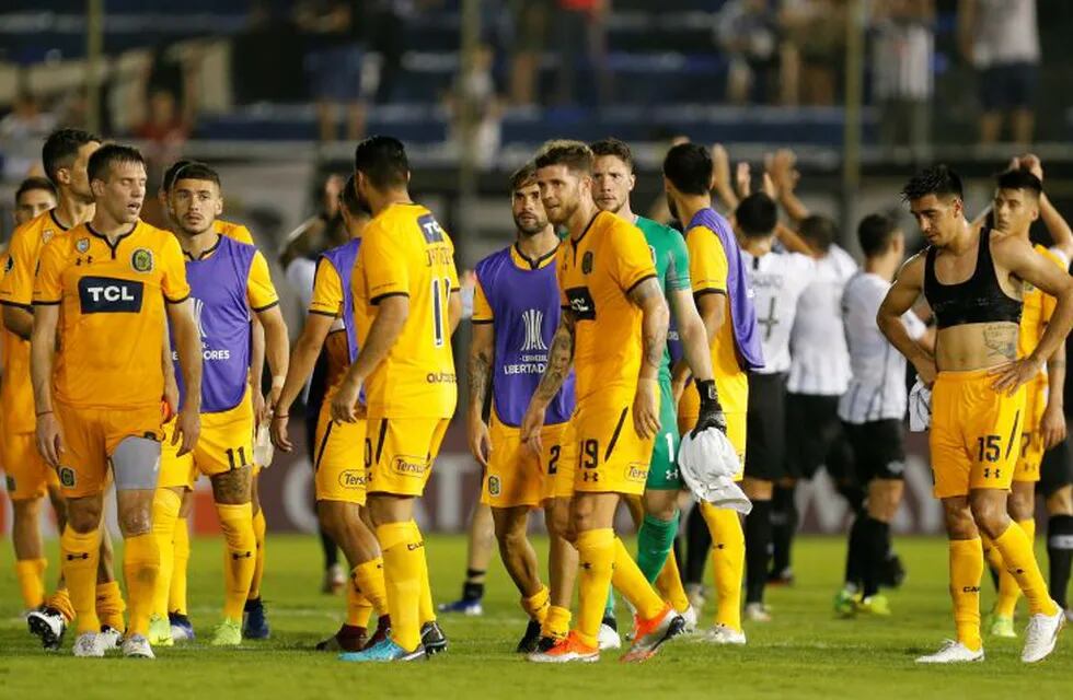 Players of Argentina's Rosario Central leave the field after losing 2-0 to Paraguay's Libertad at the end of their Copa Libertadores soccer game in Asuncion, Paraguay, Thursday, April 4, 2019. (AP Photo/Jorge Saenz)
