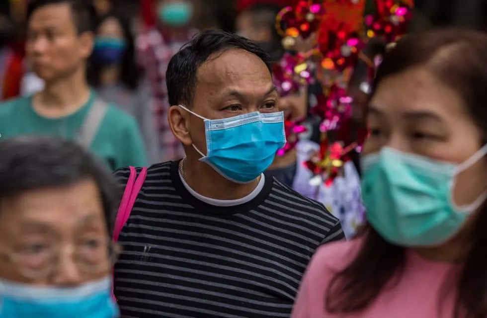 People wear masks as they visit Wong Tai Sin temple on the first day of the Lunar New Year of the Rat in Hong Kong on January 25, 2020, as a preventative measure following a coronavirus outbreak which began in the Chinese city of Wuhan. - Hong Kong on January 25 declared a mystery virus outbreak as an \