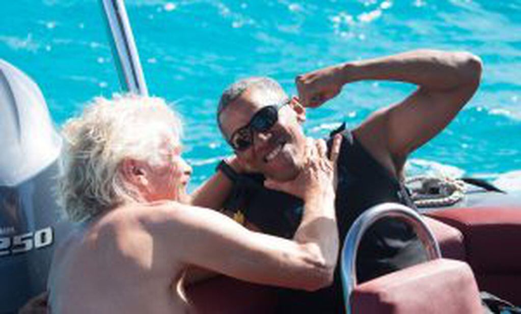 Former U.S. President Barack Obama and British businessman Richard Branson sit on a boat during Obama's holiday on Branson's Moskito island, in the British Virgin Islands, in a picture handed out by Virgin on February 7, 2017. Jack Brockway/Virgin Handout
