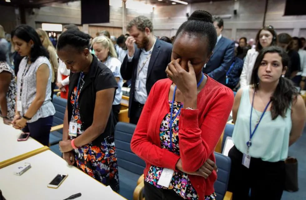 A handout photo by UNEP shows the UN Staff observing a minute of silence for the victims of the accident of the Ethiopian Airlines, including 19 UN workers, before the opening plenary of the 4th UN Environment Assembly at the UN headquaters in Nairobi, Kenya, on March 11, 2019. (Photo by UNEP/C. Villemain / UNEP / AFP)