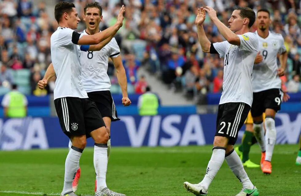 Germany's Julian Draxler, left, celebrates after scoring his side's second goal during the Confederations Cup, Group B soccer match between Australia and Germany, at the Fisht Stadium in Sochi, Russia, Monday, June 19, 2017. (AP Photo/Martin Meissner)